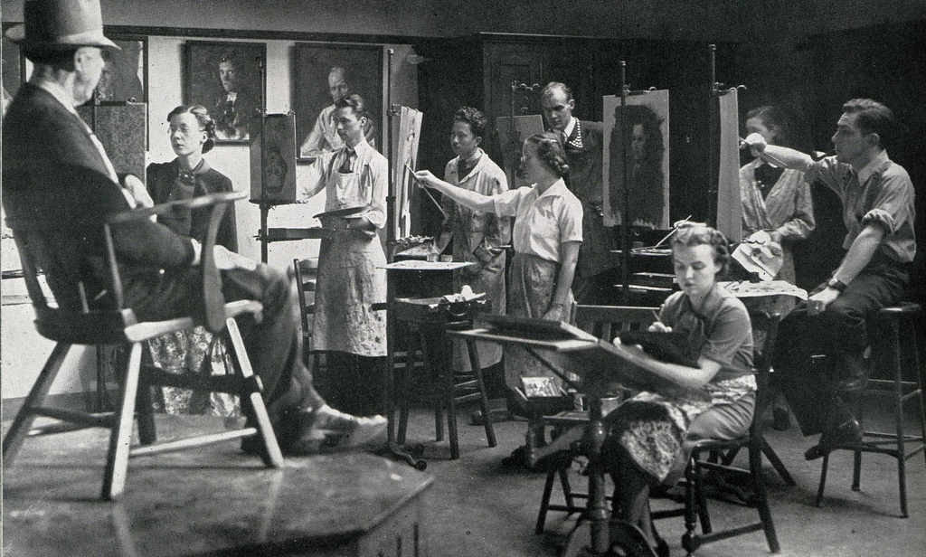 Black-and-white photo of students painting on easels in a class at the Art Building