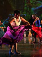 cuban dancers on stage wearing bright colors 