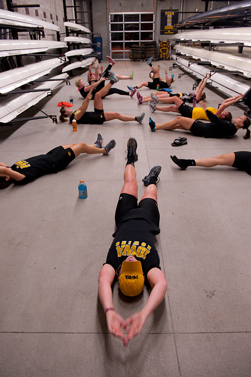 The rowing team stretches prior to practice.