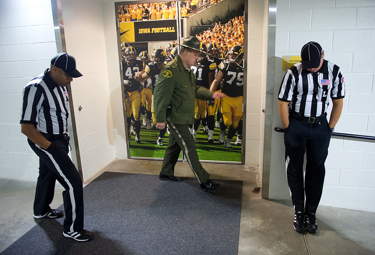 Officials wait to escort the Iowa team to the field.
