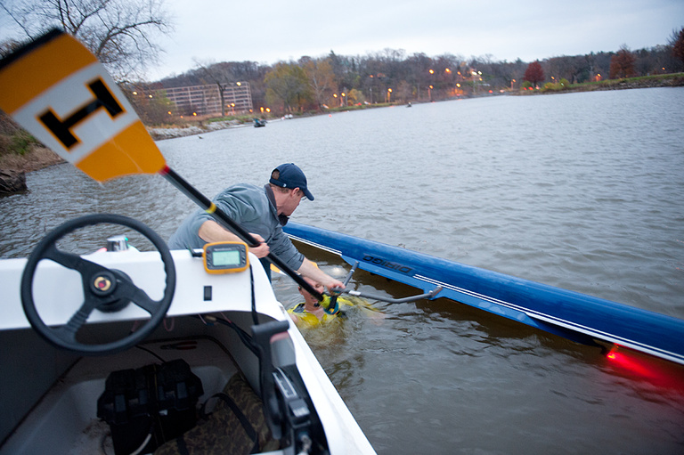 Rowing coach Steve Pritzker assists a capsized rower