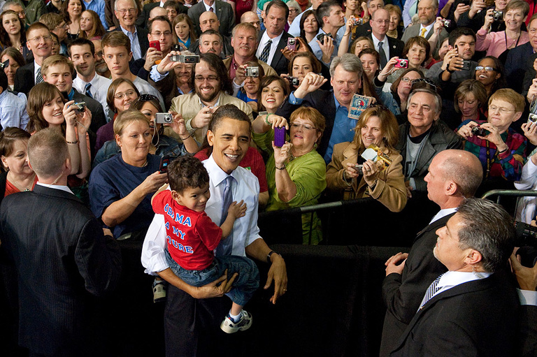 President Obama holds a young boy.
