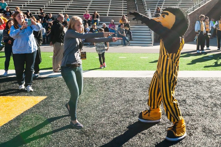 Student with Herky mascot.