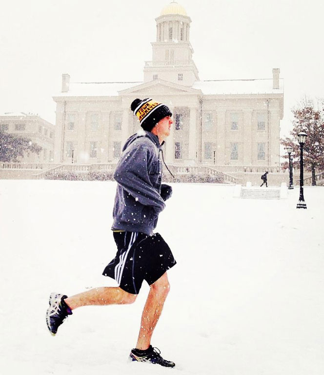 Runner with a snowy Old Capitol in the background.
