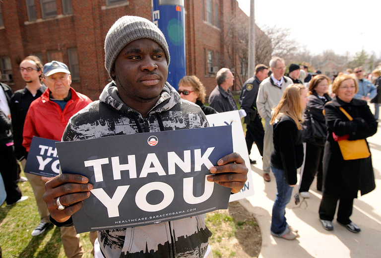 Demonstrator holds sign that reads "Thank You."