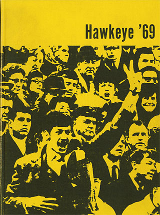 Black-and-gold cover of the 1969 Hawkeye yearbook, with a photo of a crowd and a guy flashing the peace sign
