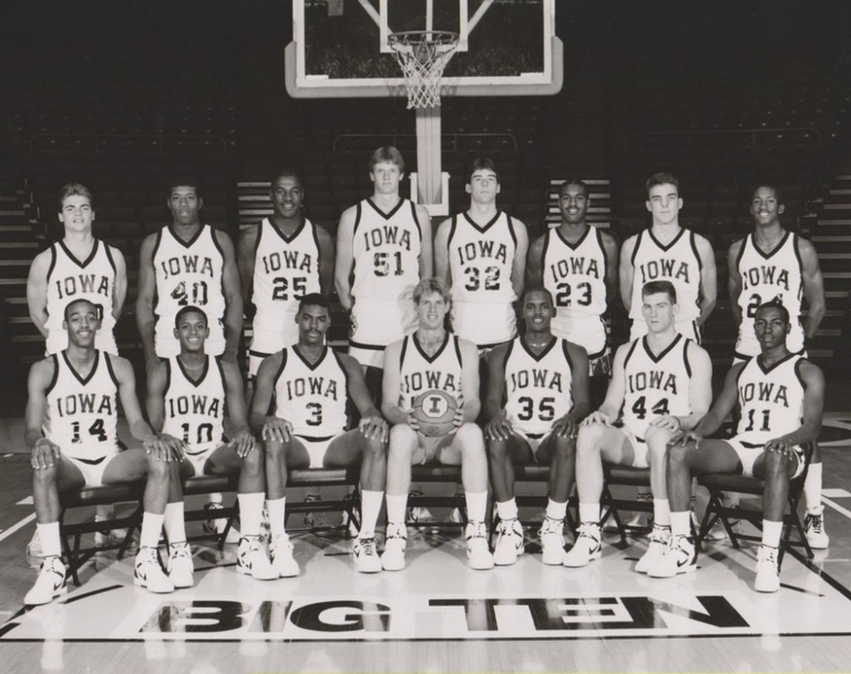 The 1986-87 Hawkeye gather around former coach Tom Davis.
