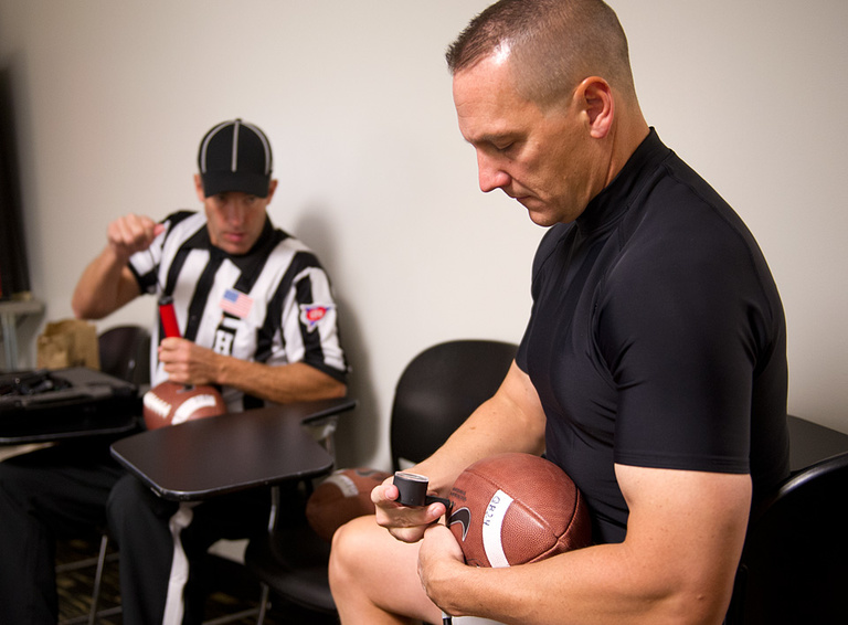 Officials make sure game balls are properly inflated.