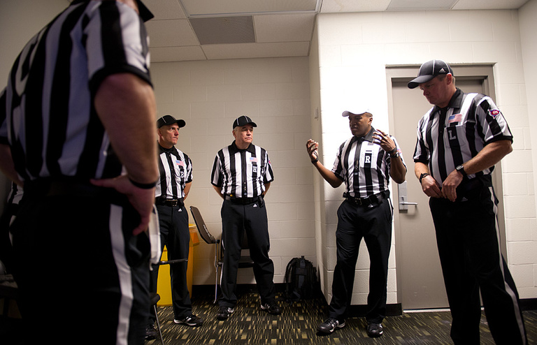 Referee Shawn Smith gives last minute instructions to his crew moments before kickoff.