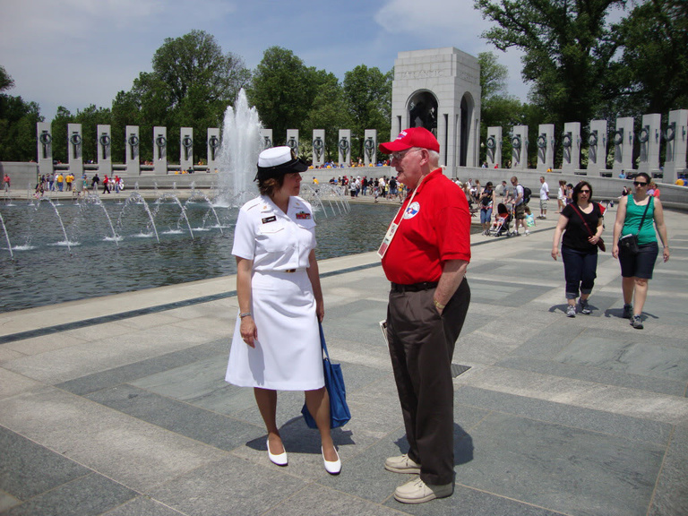 Veteran talks to a nurse in military uniform.