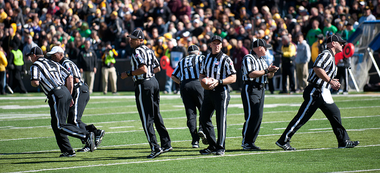 Officials split up for the kickoff.