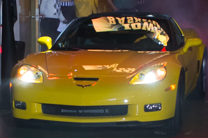 Yellow Corvette drives into Carver Hawkeye Arena.