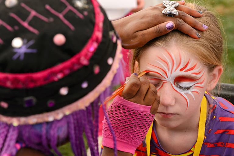 Cultural Diverity Festival 2013: A young festival participant enjoys getting her face painted by Hip Hop Hannah face painting.