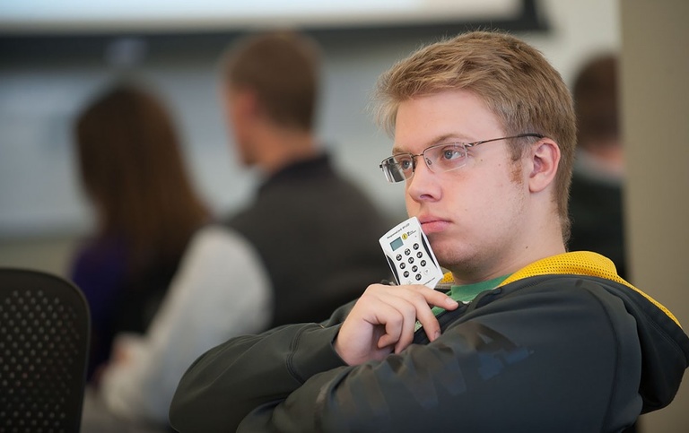 Student holding a clicker