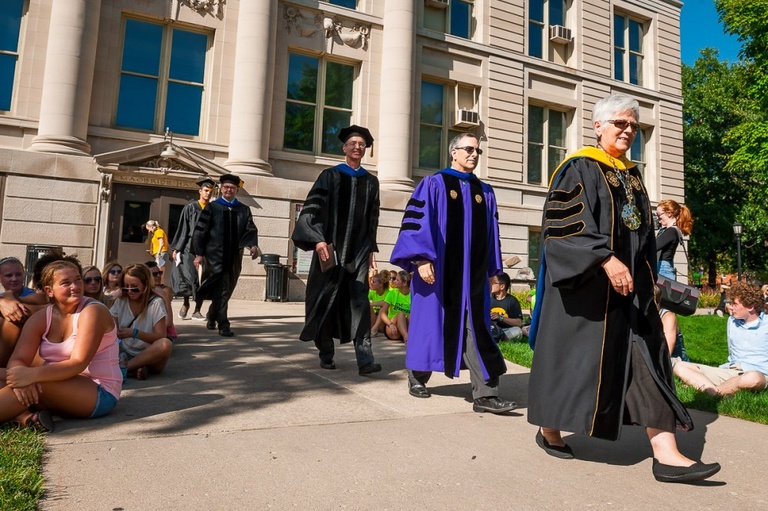UI President Sally Mason and others in traditional caps and gowns.