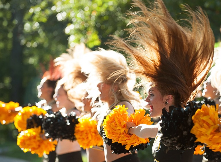 Cheerleaders with hair flying.