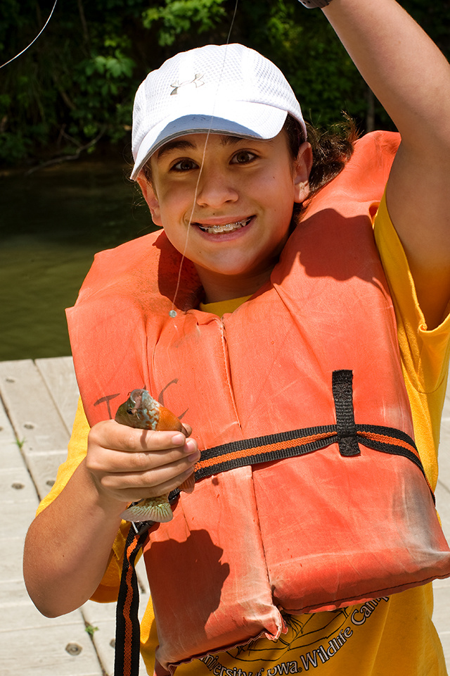 boy holding fish at wildlife camp