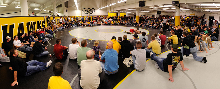 Big crowd watches wrestling action.