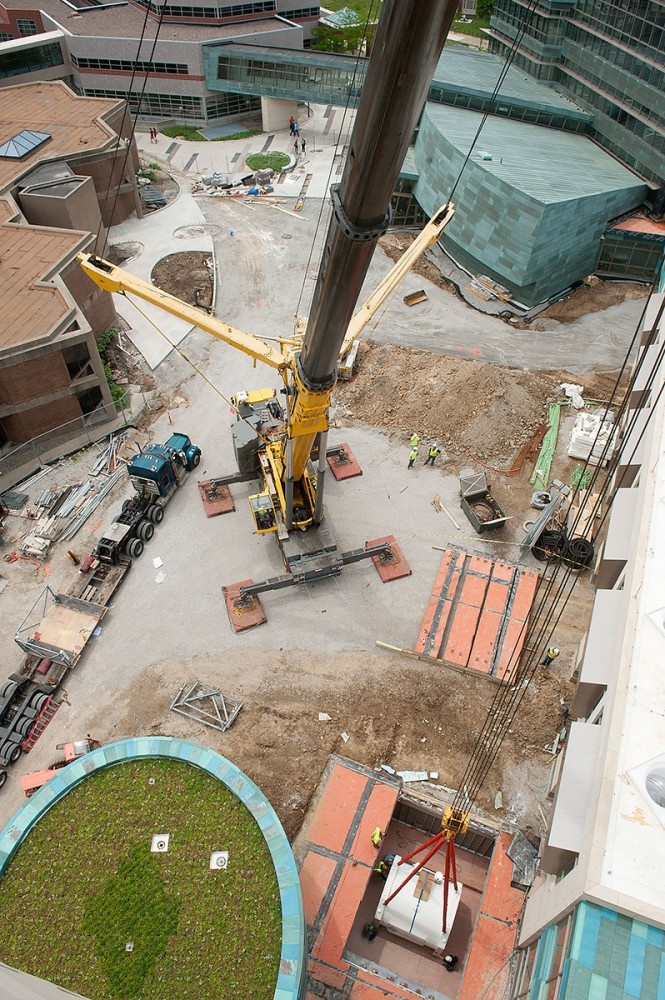An overall view of the crane lowering the magnet into place.