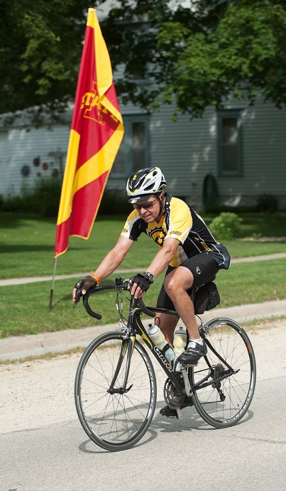 Iowa rider rides past an Iowa State flag