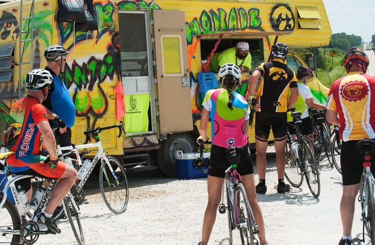 Riders wait for a beverage along the route