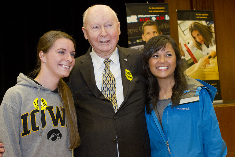 Henry B. Tippie poses with students after his talk on the effects of philanthropy, and the importance of finding a way to give back to the UI.