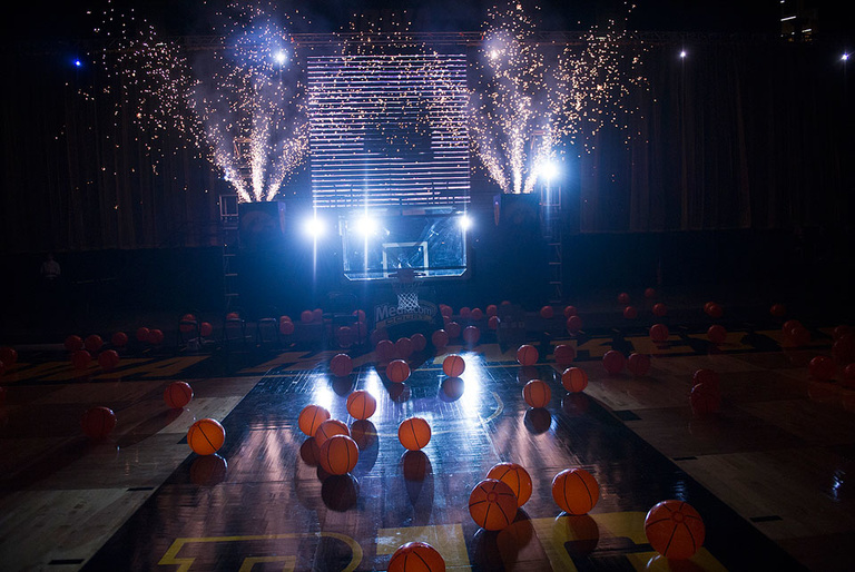 Fireworks and inflatable basketballs decorate the court.