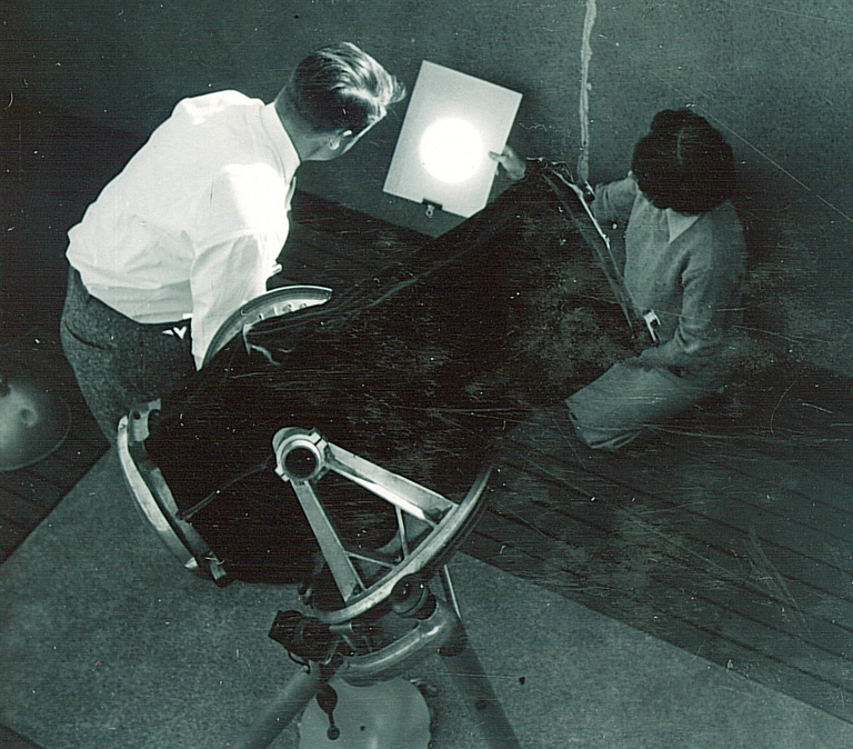 Two people working inside a campus observatory