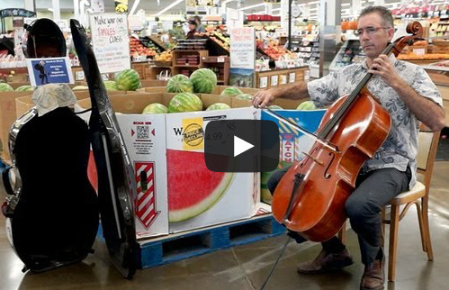 A professor plays the violin in an Iowa City grocery store