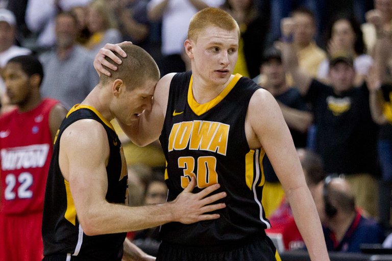 Iowa basketball player Matt Gatens (5) leans his head agains the right arm of Iowa basketball player Aaron White (30) with his eyes closed in the final seconds of the game.