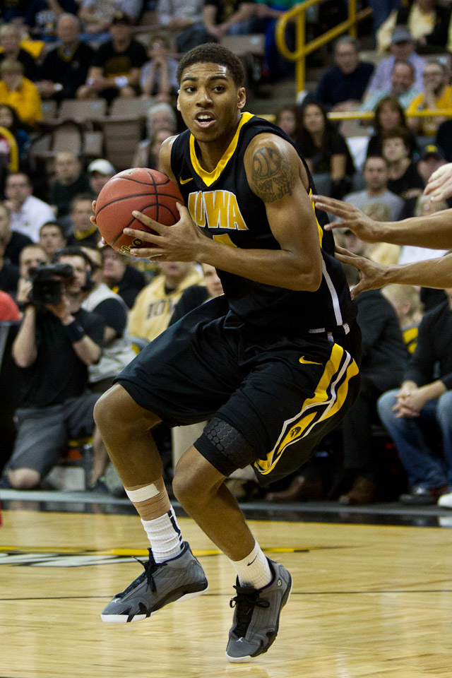 Iowa basketball player Roy Devyn Marble drives toward the basket holding the ball in both hands.