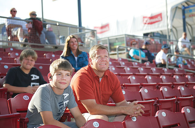 Jack Bickel with parents at a baseball game