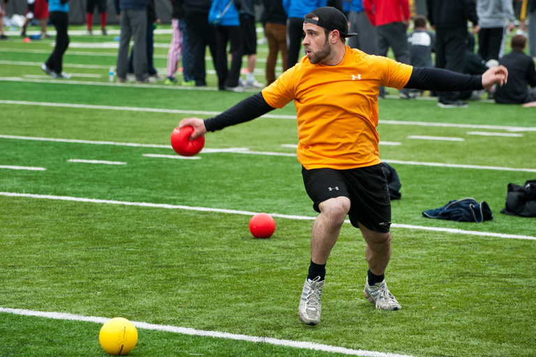 A dodgeball player dances to regain his balance during a game