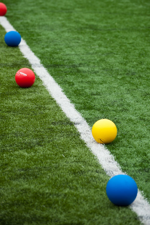 brightly colored dodgeballs lay on the Kinnick Stadium turf