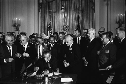 President Johnson signing the Civil Right Act, 1964.