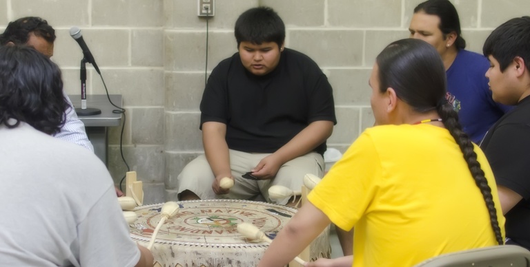 Members of Native Youth Standing Strong take part in a drum circle. 