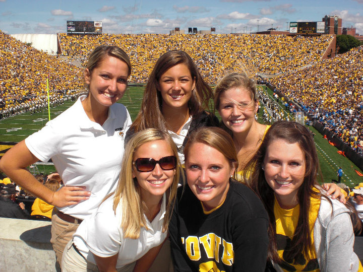Iowa student Erica Miller poses with a friends during a football game at Kinnick Stadium.  