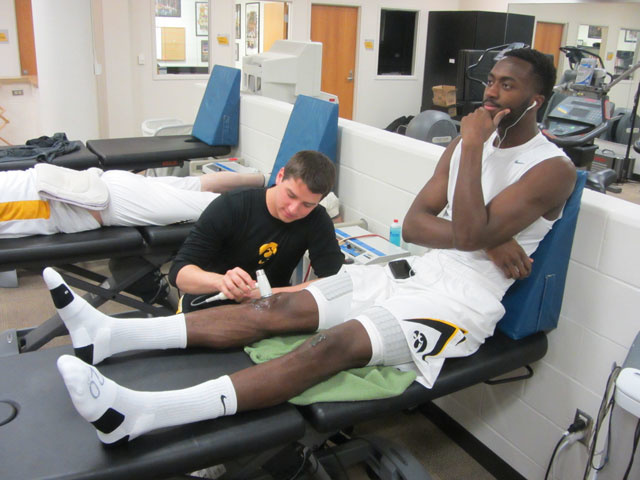 a student doing hands on athletic training
