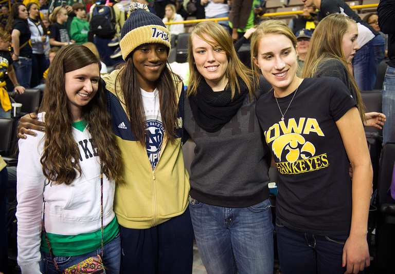 Iowa fans pose for pictures with Notre Dame team members.
