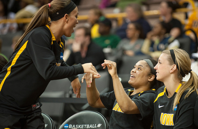 Iowa's Trisha Nesbitt hands out high fives on the bench as the outcome of the game became obvious.