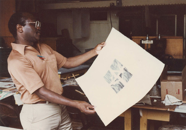 Leon Hicks looking at a print