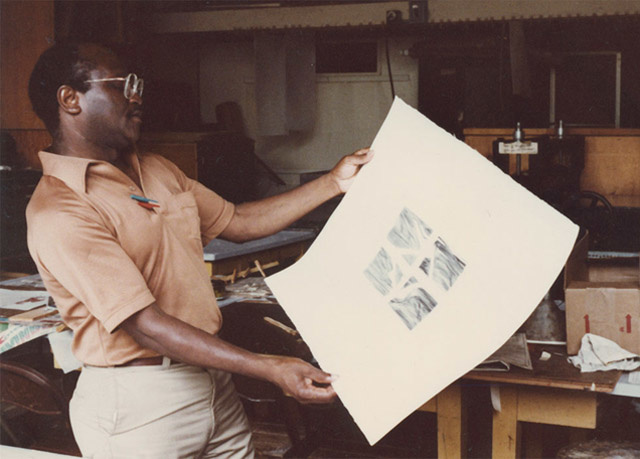 Leon Hicks looking at a print.