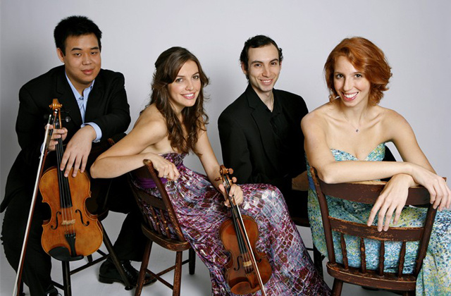 members of the Linden String Quartet sitting on chairs