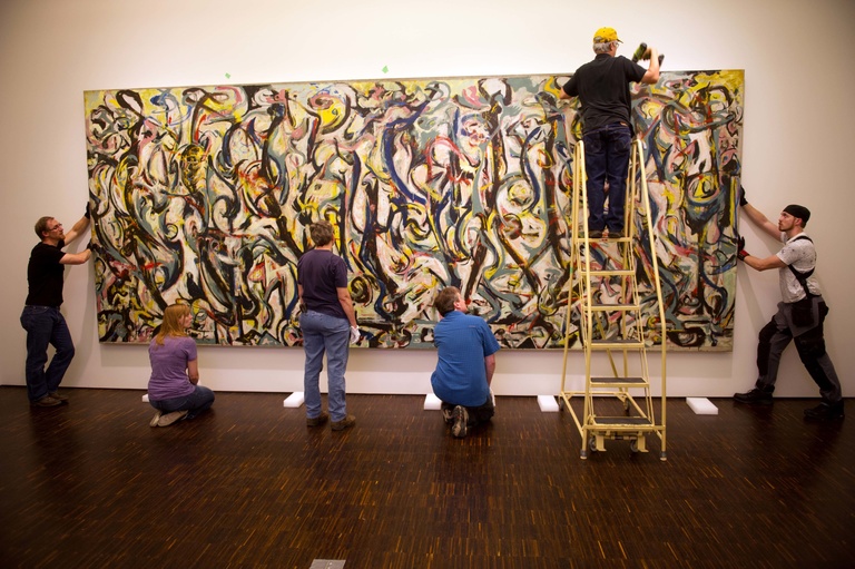 Workers remove Mural from the Figge Museum earlier this year
