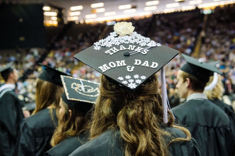 Graduation cap decorated, "Thanks Mom & Dad."