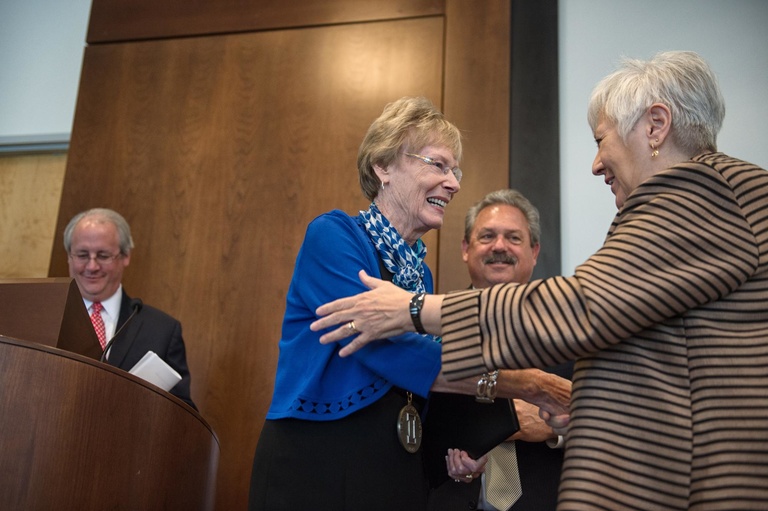 UI President Sally Mason congratulates 2015 Distinguished Alumni Award recipient Sally Mathis Hartwig. 