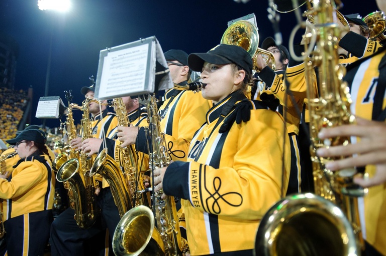 Tenor sax section of the marching band in the stands.