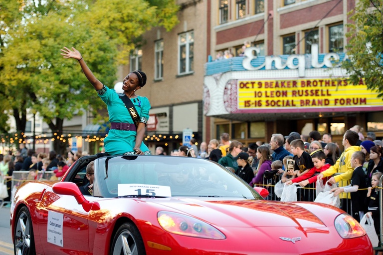 homecoming court candidate waves to crowd outside Englert Theatre