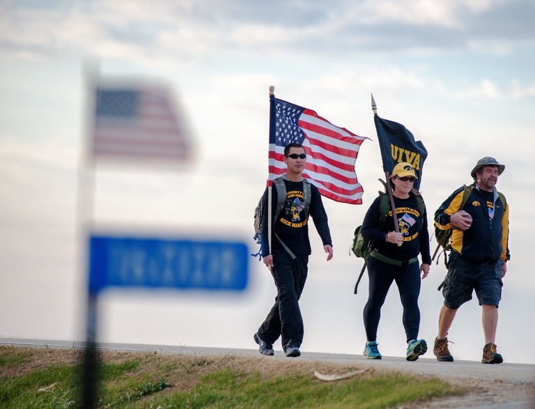 University of Iowa graduate and veteran Randy Miller (right), rucks alongside USAF veteran Patty Considine, and Iowa National Guardsman Jimmy Luu on Tuesday, Nov. 10 as part of the UIVA's Game Ball Ruck for veteran suicide awareness.