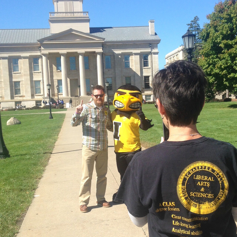 Lisa Gray, administrative services coordinator in the College of Liberal Arts & Sciences, snaps a photo of colleague Troy Fitzpatrick, Communication Studies administrator, with Herky the Hawk. Herky made an appearance to help CLAS faculty and staff celebr
